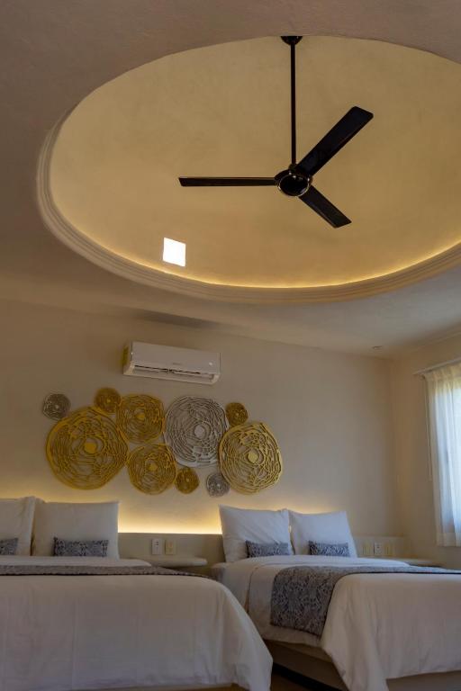 Postel nebo postele na pokoji v ubytování Hotel Circulo Bacalar