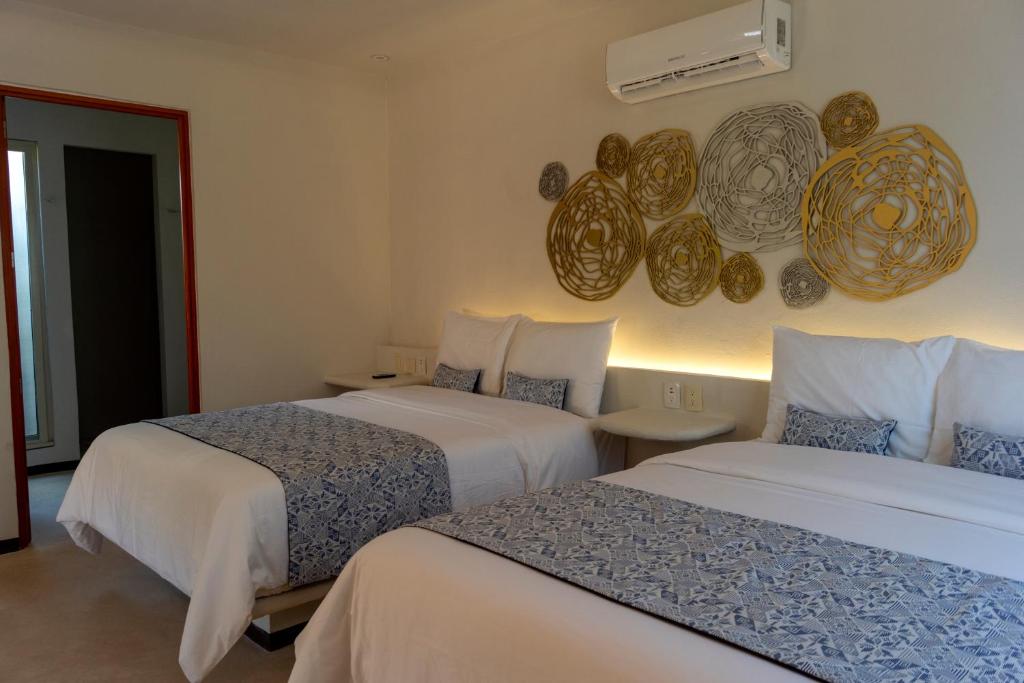 Postel nebo postele na pokoji v ubytování Hotel Circulo Bacalar