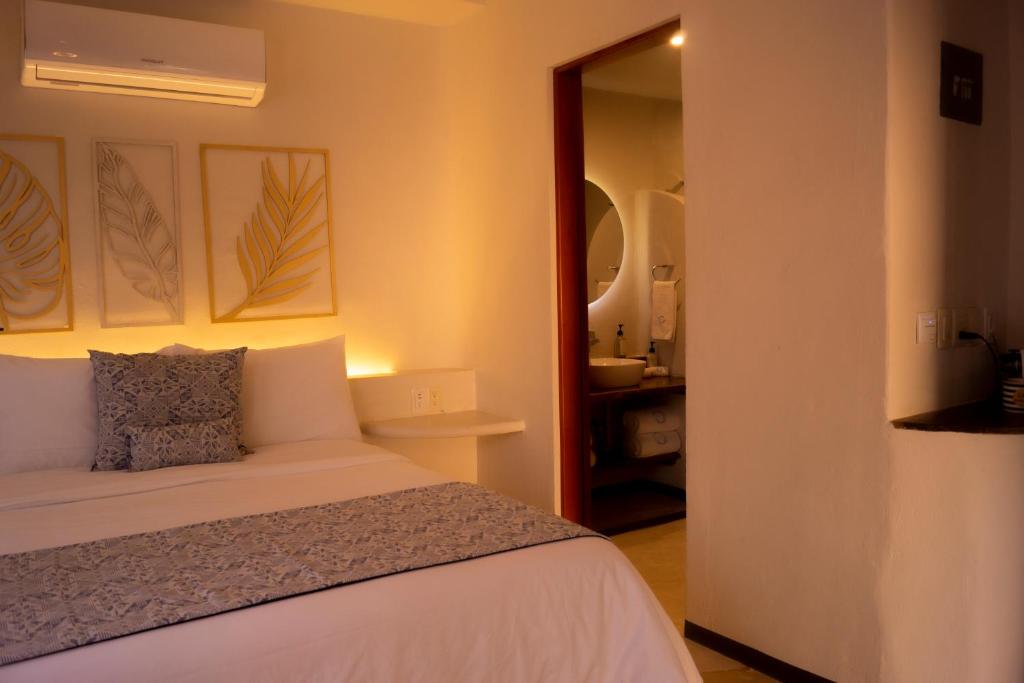 Postel nebo postele na pokoji v ubytování Hotel Circulo Bacalar