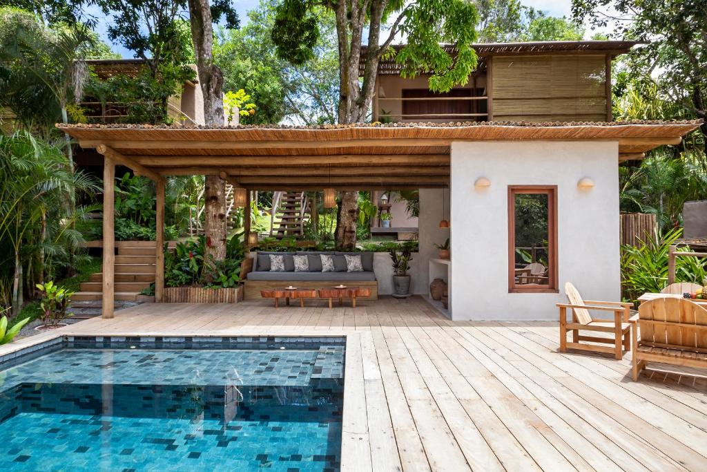 a house with a swimming pool and a patio at VILA 335 Trancoso in Trancoso