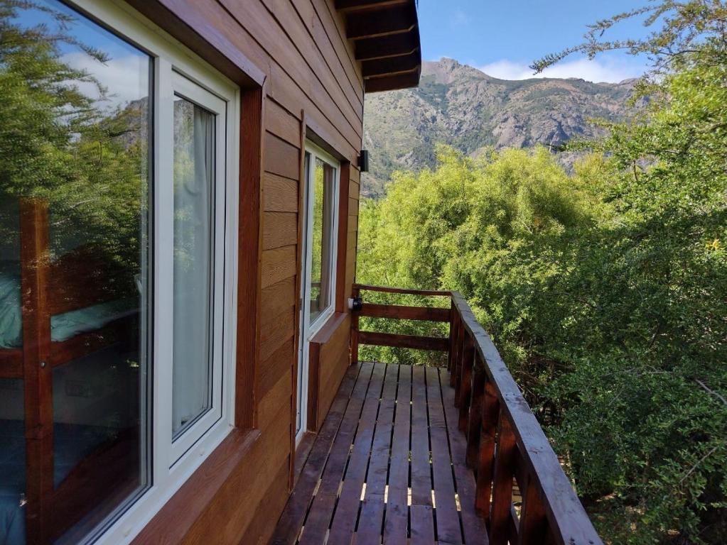 a balcony of a house with a view of the mountains at Cabaña Los Cipreses in San Carlos de Bariloche