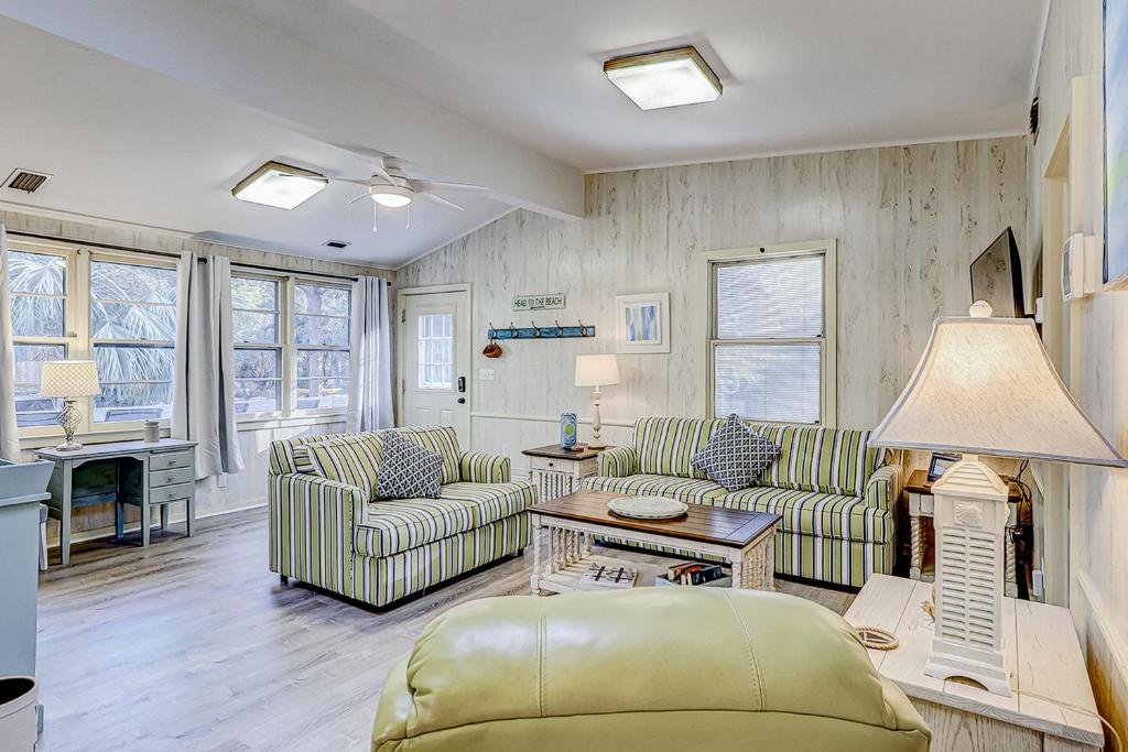 a living room with two couches and a table at Moonshell 3 in Hilton Head Island