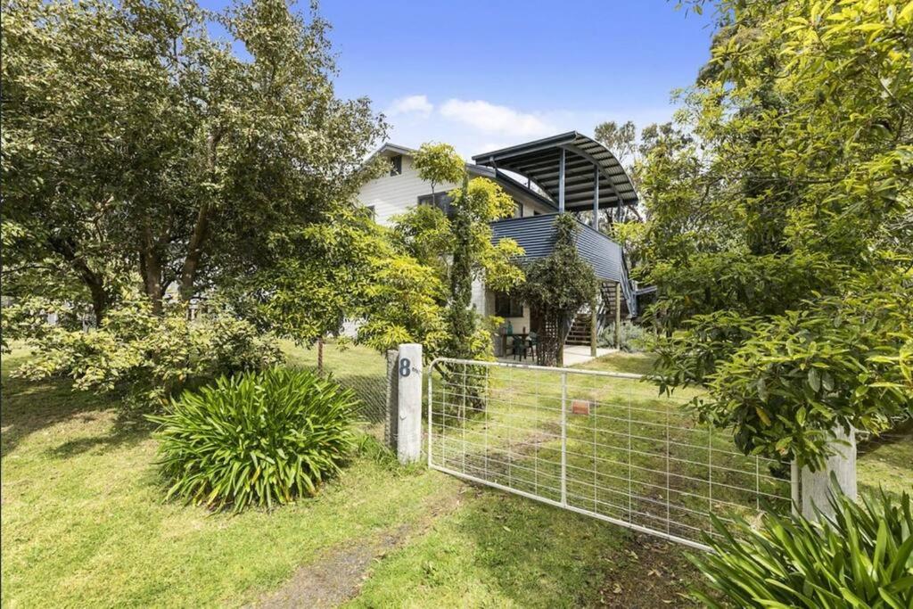 a fence in front of a house at Phillip Island Time - Large home with self-contained apartment sleeps 11 in Cowes