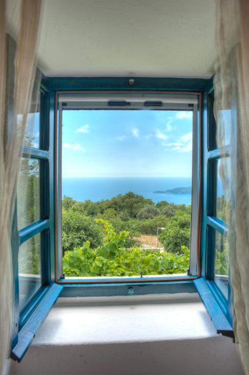 an open window with a view of the ocean at Village house Neda in Sveti Stefan
