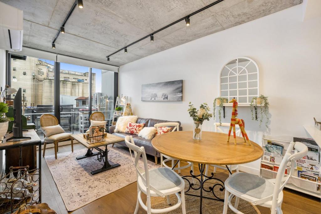 a living room with a table and a couch at Luxury African themed apartment☆10min to MCG & Swan St☆On-site Parking☆Balcony☆Rooftop deck☆Gym☆ in Melbourne