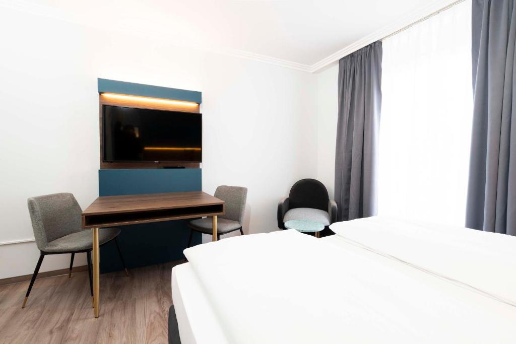 Postel nebo postele na pokoji v ubytování Hotel Rosenhof bei Bamberg