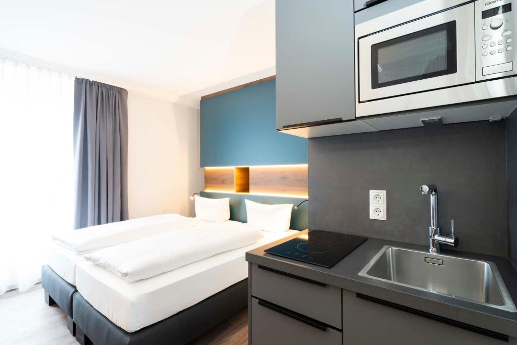 a hotel room with a bed and a microwave at Hotel Rosenhof bei Bamberg in Kemmern