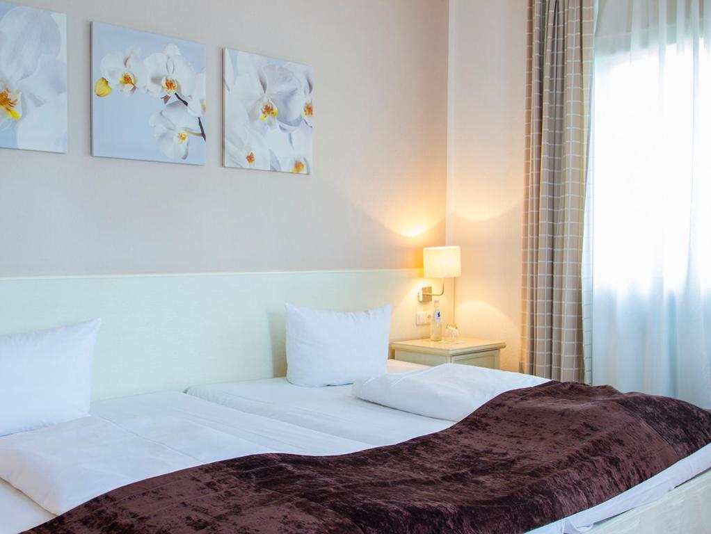 Postel nebo postele na pokoji v ubytování Hotel Schlee