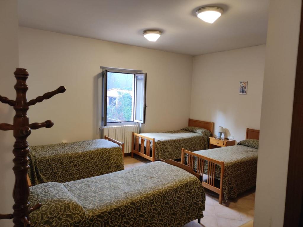 Posteľ alebo postele v izbe v ubytovaní QOELET - B&B Etico e Sociale