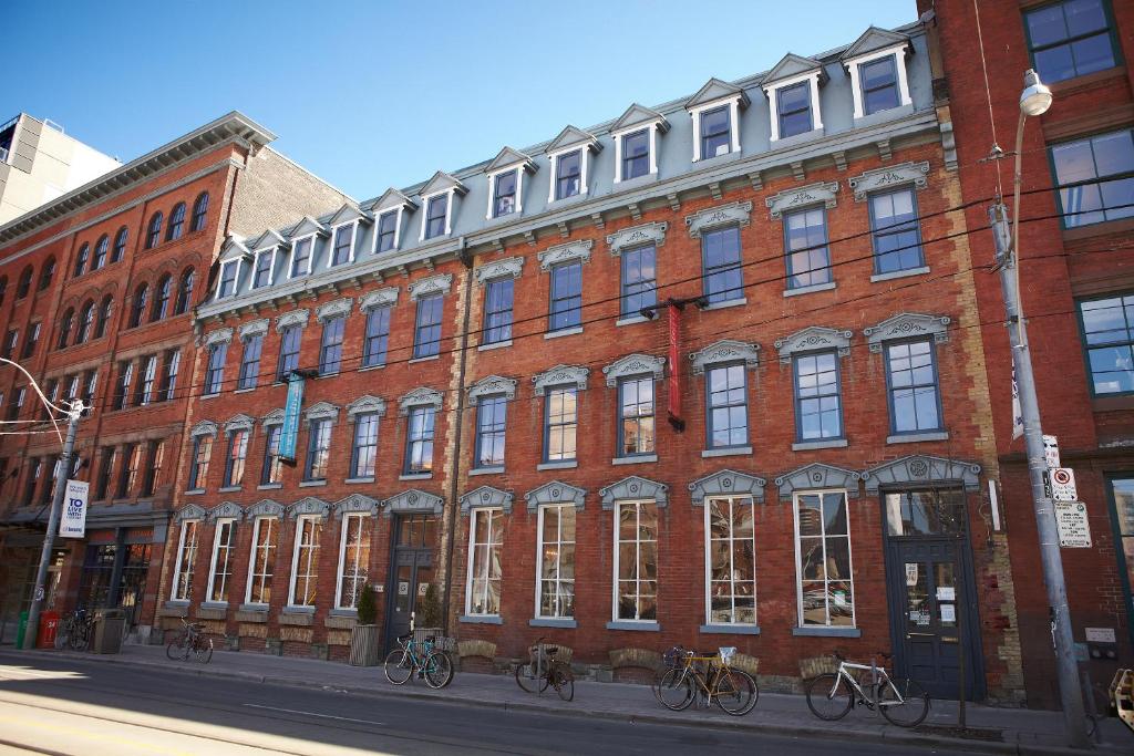 a large brick building with bikes parked in front of it at The Ivy at Verity in Toronto