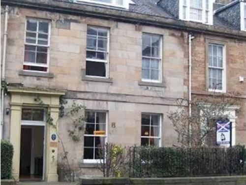 a large brick building with a large window at Ivy Braveheart Guest House in Edinburgh