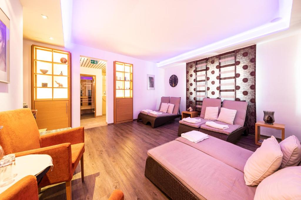 a living room with a bed and a dining room at Der Winklhof in Saalfelden am Steinernen Meer