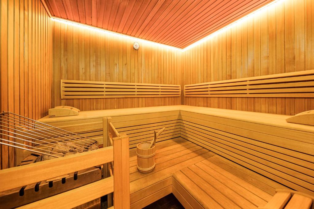 a large wooden sauna with a bench in it at Der Winklhof in Saalfelden am Steinernen Meer
