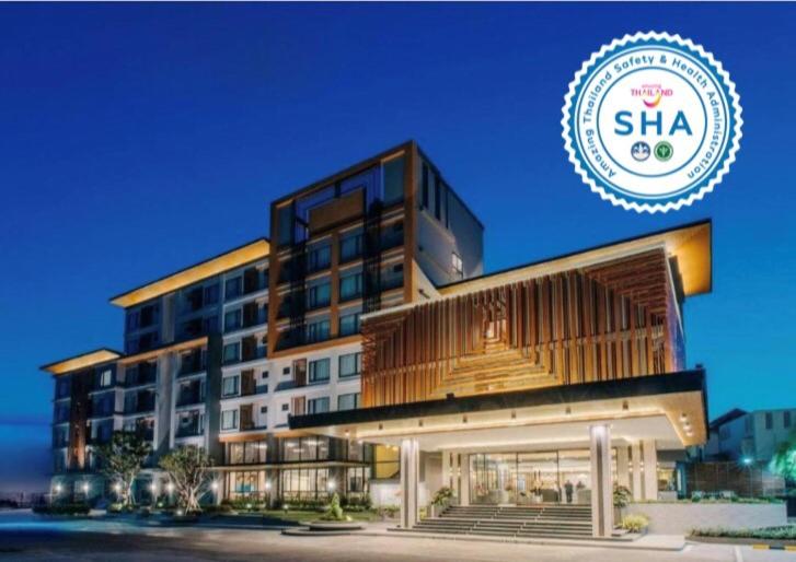 a large building with a sign in front of it at Arista Hotel Ubon in Ubon Ratchathani