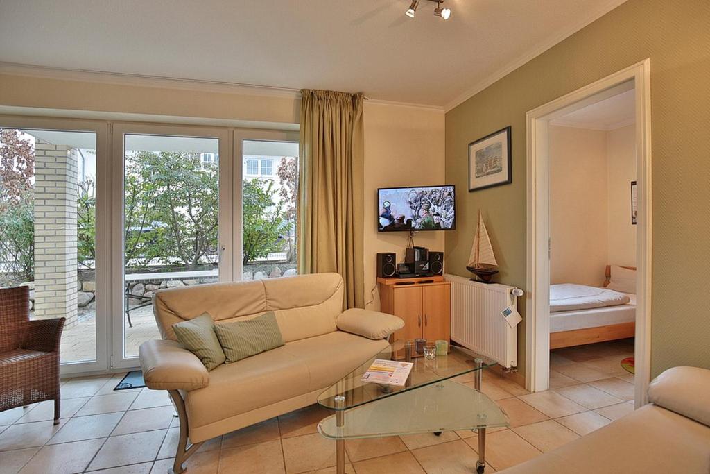 ein Wohnzimmer mit einem Sofa und einem TV in der Unterkunft Moderne Strandvilla Moderne Strandvilla Appartement 2 in Timmendorfer Strand