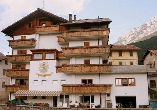 a large building with wooden balconies on it at Hotel Villanova in Santo Stefano di Cadore