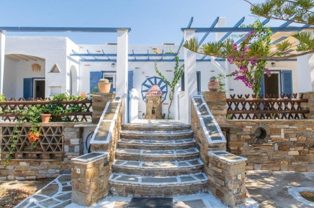 a set of stairs in front of a house at Θἔρως (Theros) house 1 - Agios Fokas in Tinos