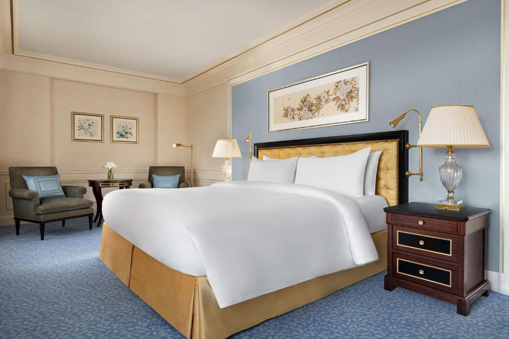 a large white bed in a hotel room at Shangri-La Paris in Paris