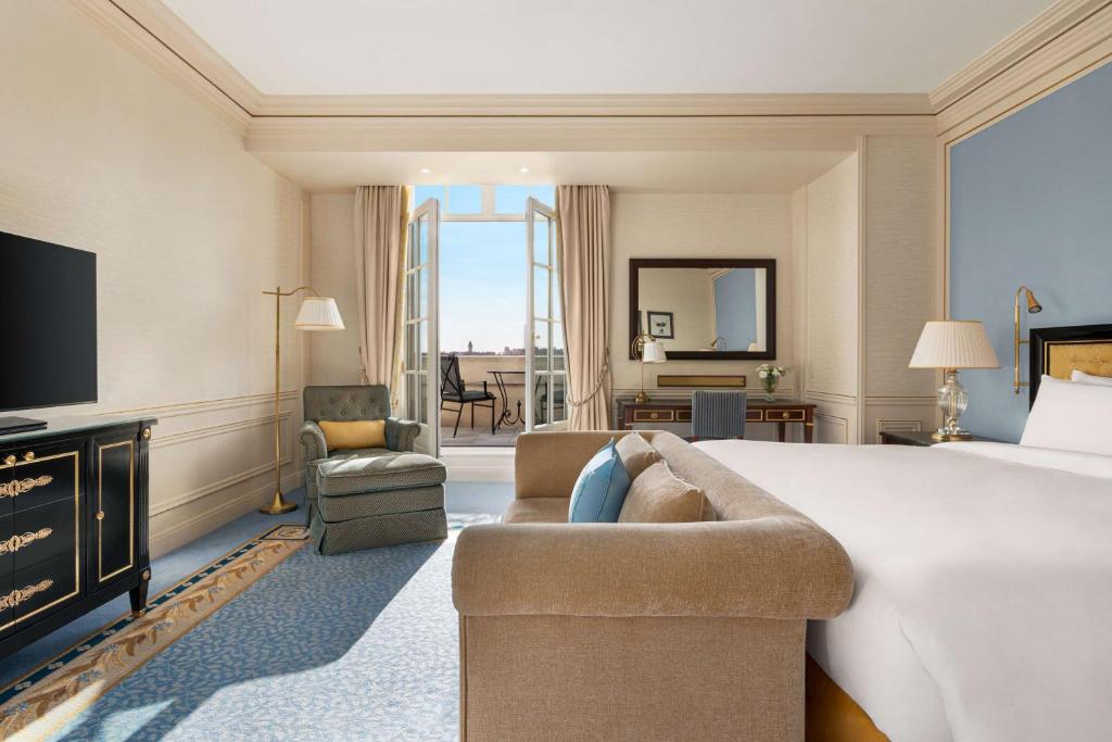 a hotel room with a king sized bed and a fireplace at Shangri-La Paris in Paris