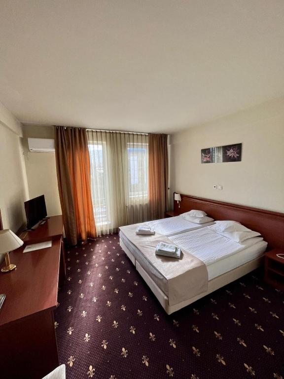 Postel nebo postele na pokoji v ubytování Hotel Seven