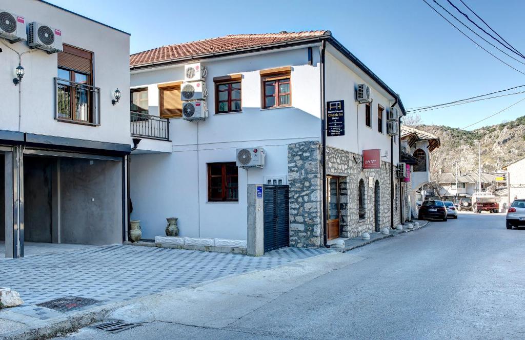 a building on the side of a street at Guesthouse Check In in Stolac