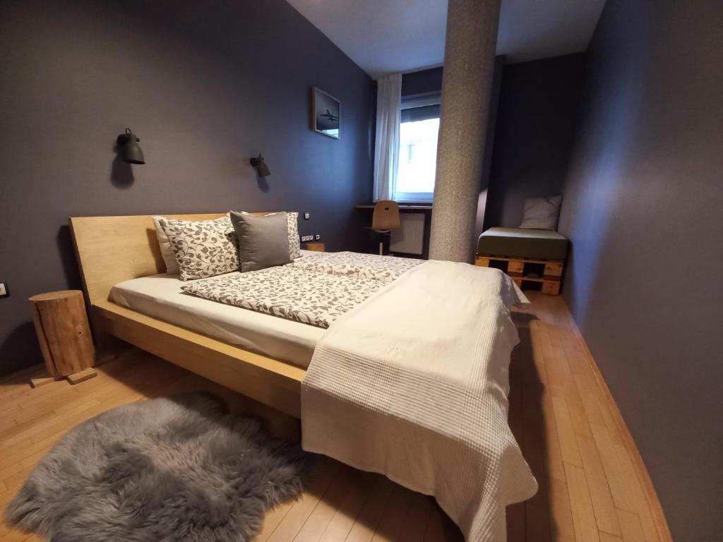 a bedroom with a large bed with a rug at InnerCity Apartments in Budapest