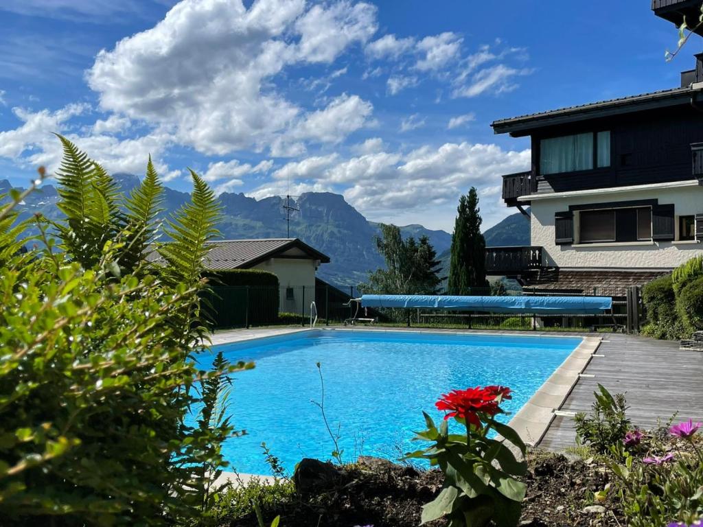 a swimming pool in front of a house at Le rêve de Lou et balou in Saint-Gervais-les-Bains