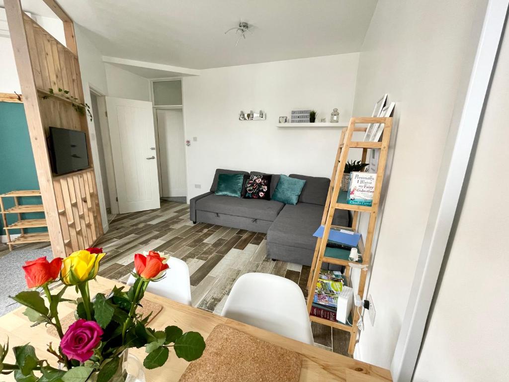 a living room with a couch and a table at The Corner House - Modern Chesterfield Town Centre Apartments in Chesterfield