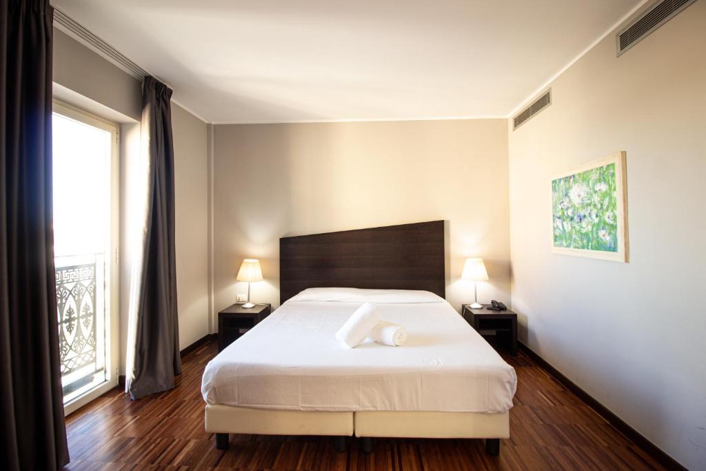 Postel nebo postele na pokoji v ubytování Hotel Cavour by LVG Hotel Collection