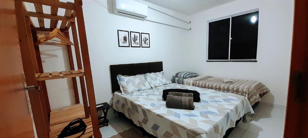 a small bedroom with a bed and a ladder at Apartamento Beira Rio no Condomínio Brisas do Lago in Paulo Afonso
