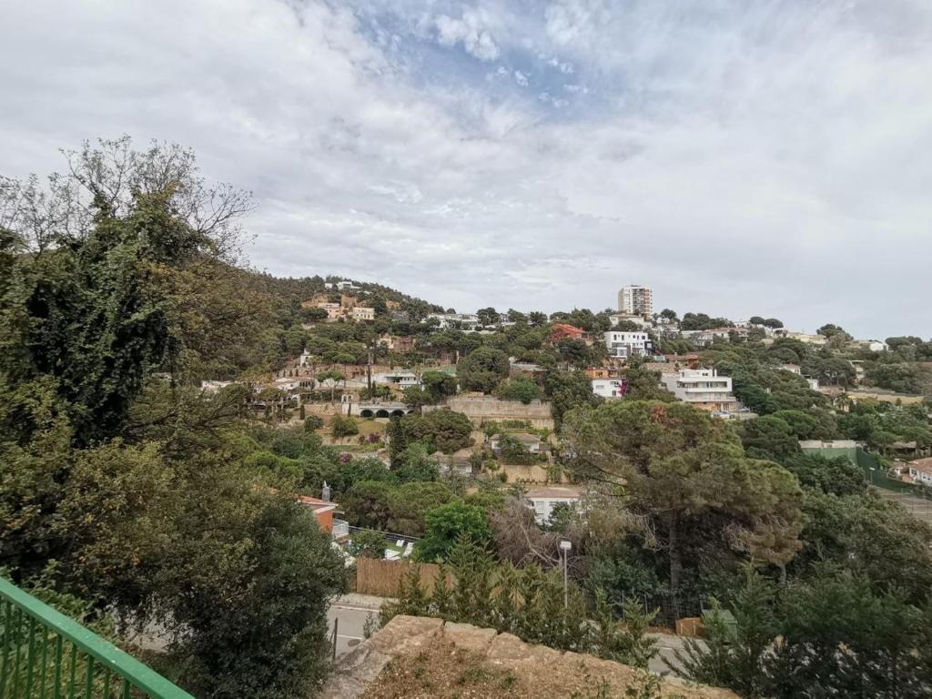 a town on a hill with trees and buildings at Canyelles BBQ Apartment in Lloret de Mar