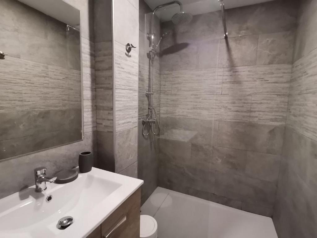 a bathroom with a sink and a toilet and a shower at Canyelles BBQ Apartment in Lloret de Mar