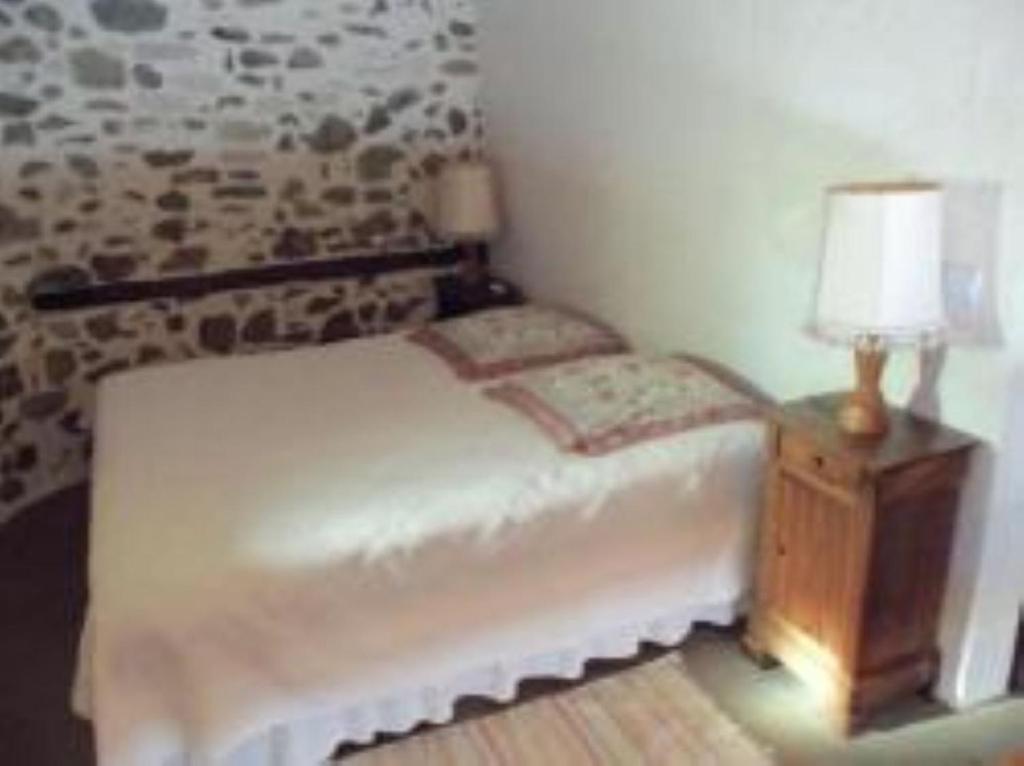 Postel nebo postele na pokoji v ubytování L'Oustal Chambres et Tables d'Hôtes