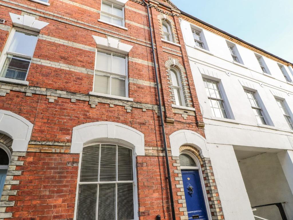 a red brick building with a blue door at The Townhouse in York