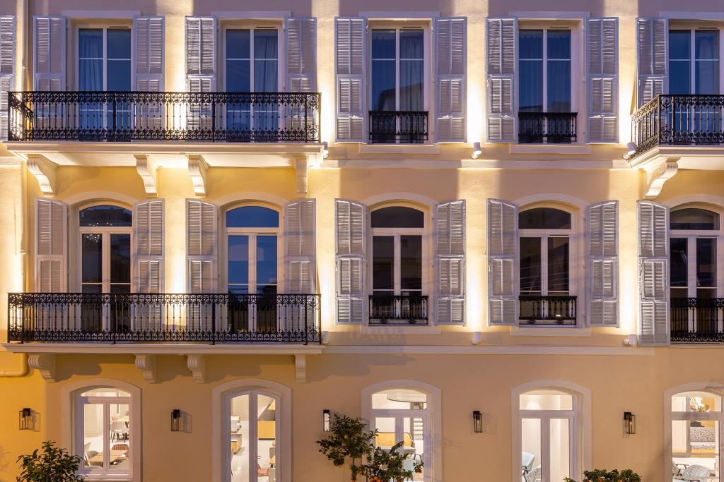 a facade of a building with windows and balconies at Hôtel Apollinaire Nice in Nice