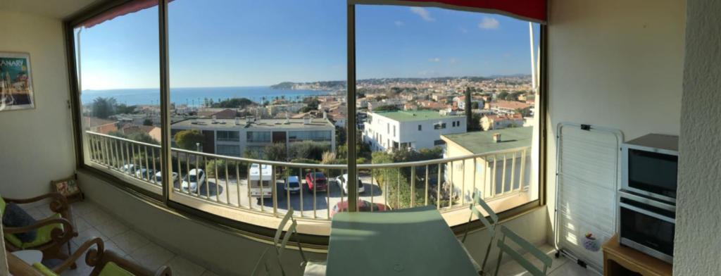 a balcony with a large view of a city at Charming Studio With Terrace And 180 Sea View in Six-Fours-les-Plages