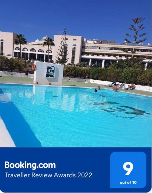 a large blue swimming pool with people in it at Cristimar - stunning Vacation Rental Home for families & friends in Los Cristianos
