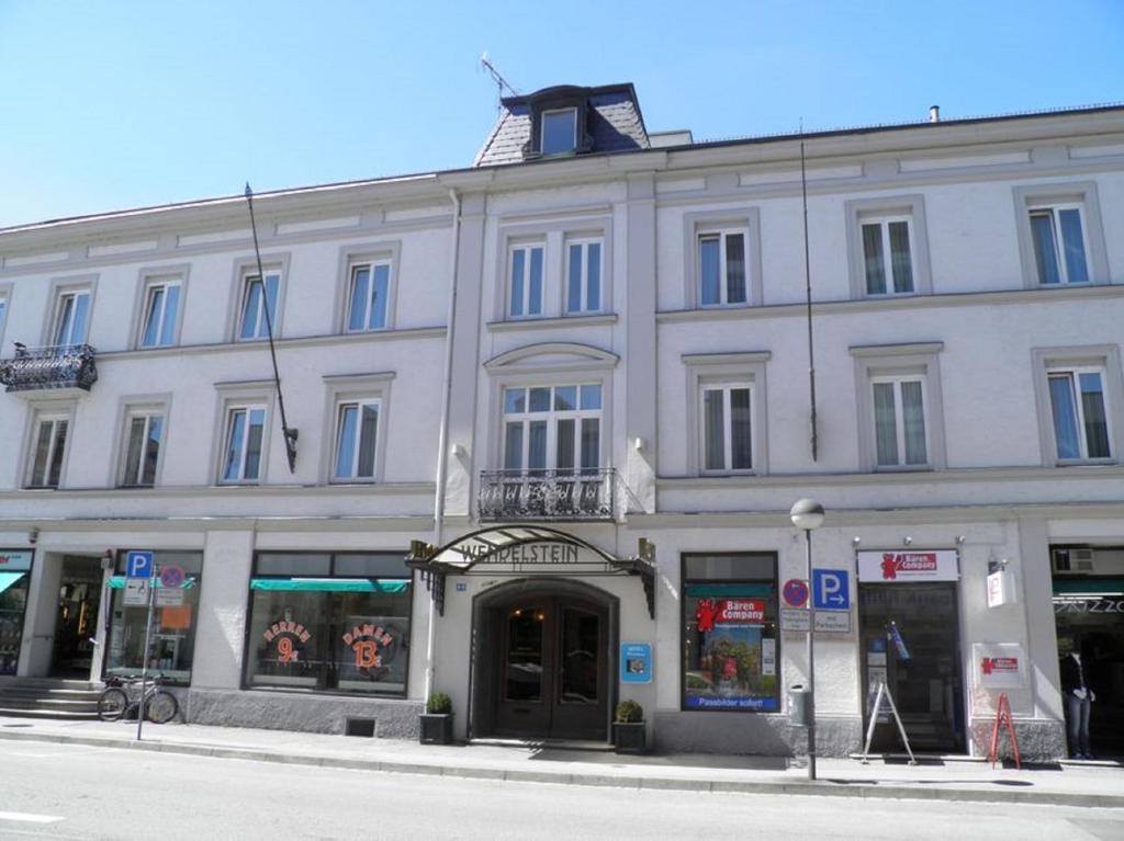 a large white building on the corner of a street at Hotel Wendelstein in Rosenheim
