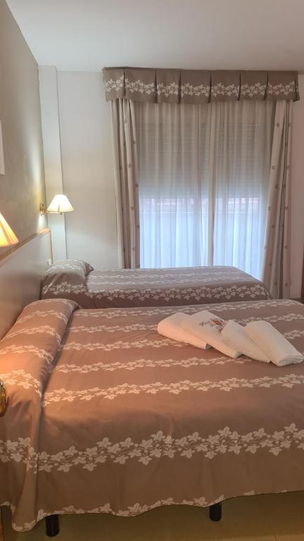 Postel nebo postele na pokoji v ubytování Hotel Cosmos Tarragona