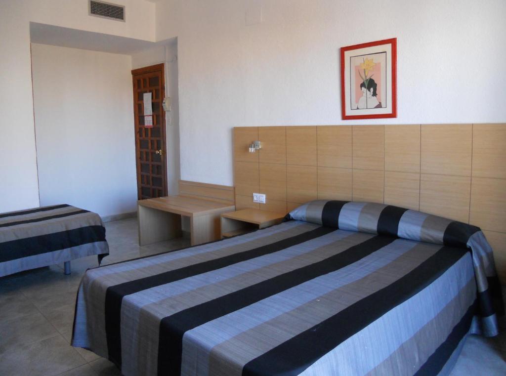Un dormitorio con una cama grande en una habitación. en Hotel Sacratif, en Torrenueva