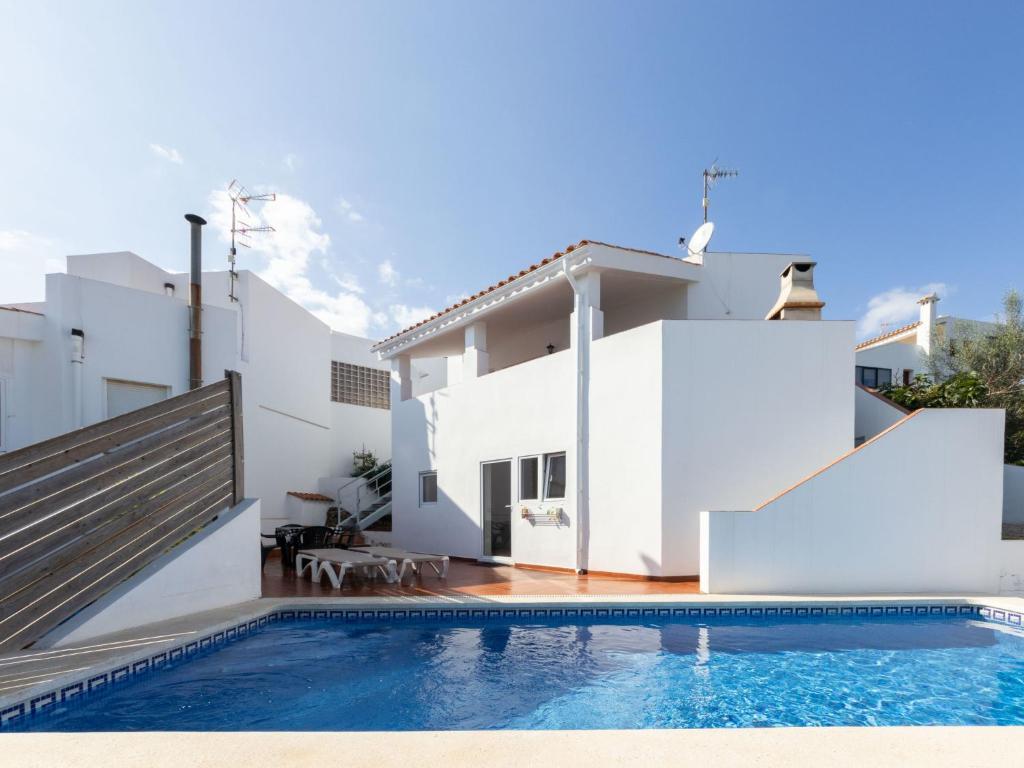 a villa with a swimming pool in front of a house at Holiday Home Sascha by Interhome in Peñíscola