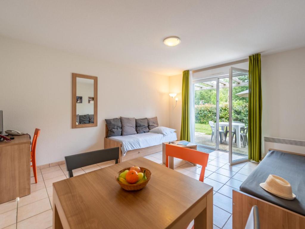 a living room with a couch and a table at Holiday Home Cottage Confort 3 Pers- by Interhome in Saumur