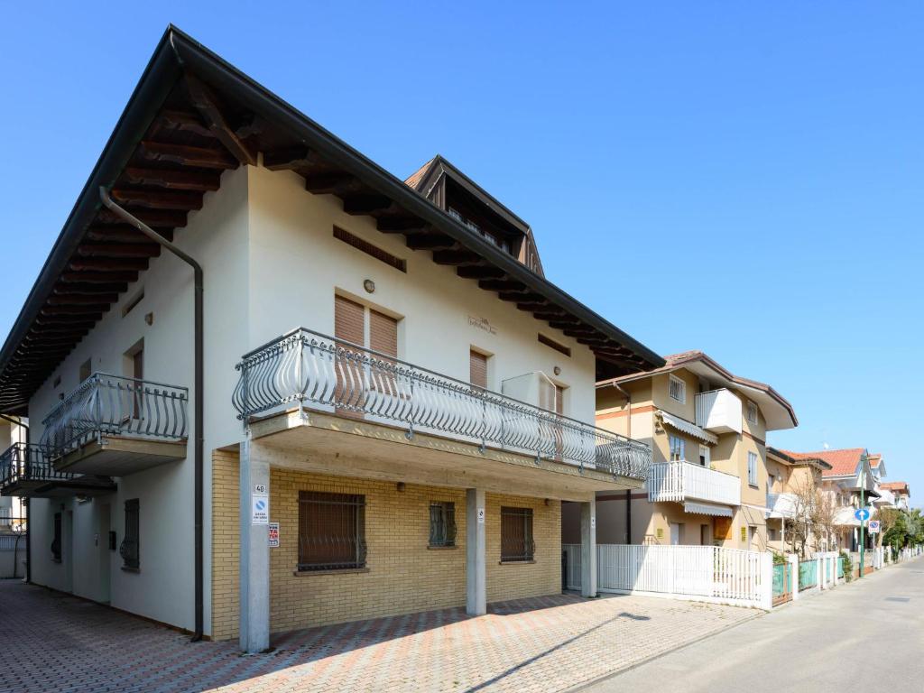 an apartment building with balconies on a street at Apartment Guglielmo e Anna by Interhome in Lignano Sabbiadoro