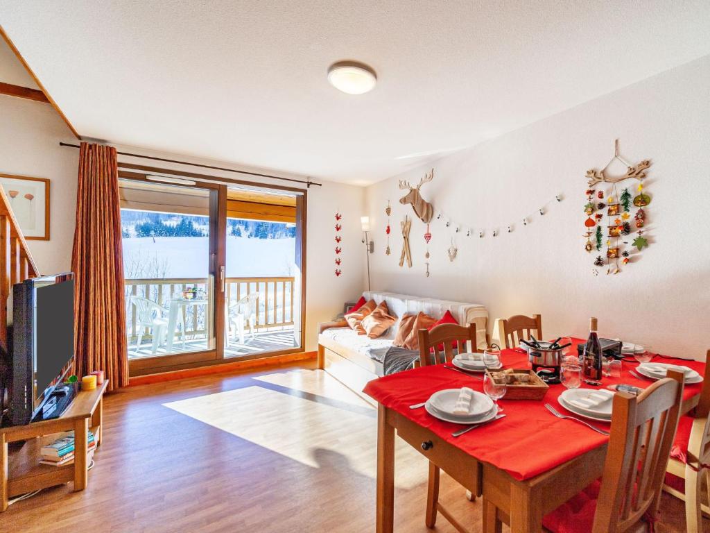 un salon avec une table et un tissu de table rouge dans l'établissement Apartment Les terrasses des bottières-1 by Interhome, à Saint-Pancrace
