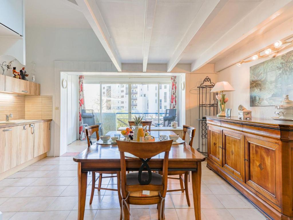 a kitchen with a table and chairs and a dining room at Apartment Les Jardins du Nil by Interhome in Cap d'Agde
