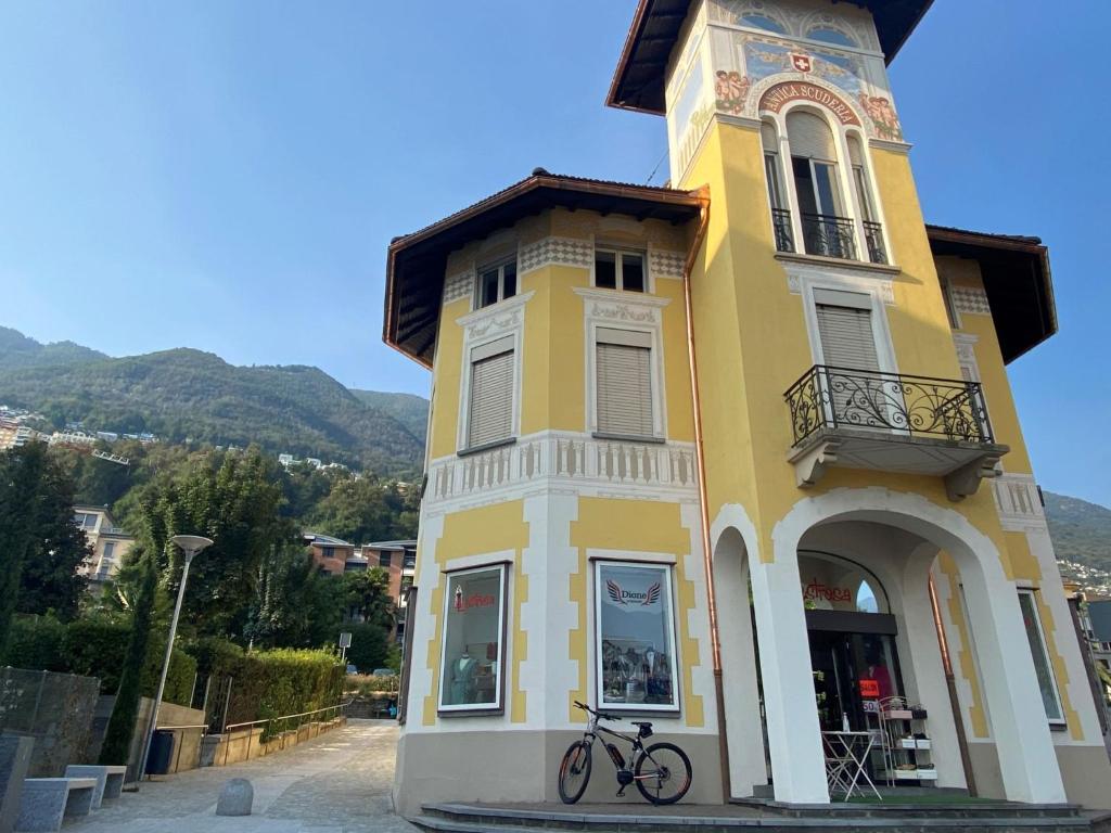 a yellow building with a bike parked in front of it at Apartment Antica Scuderia by Interhome in Muralto