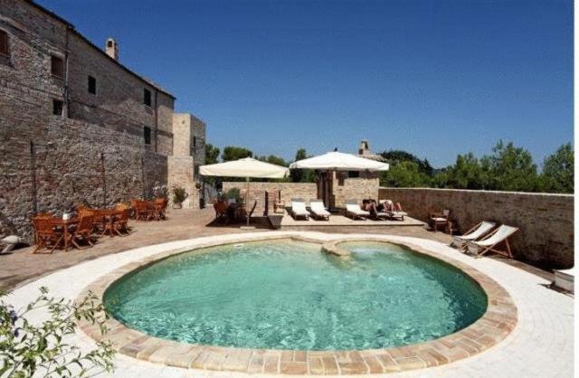 a large swimming pool in front of a building at Residence Borgo Da Mare in Monteprandone