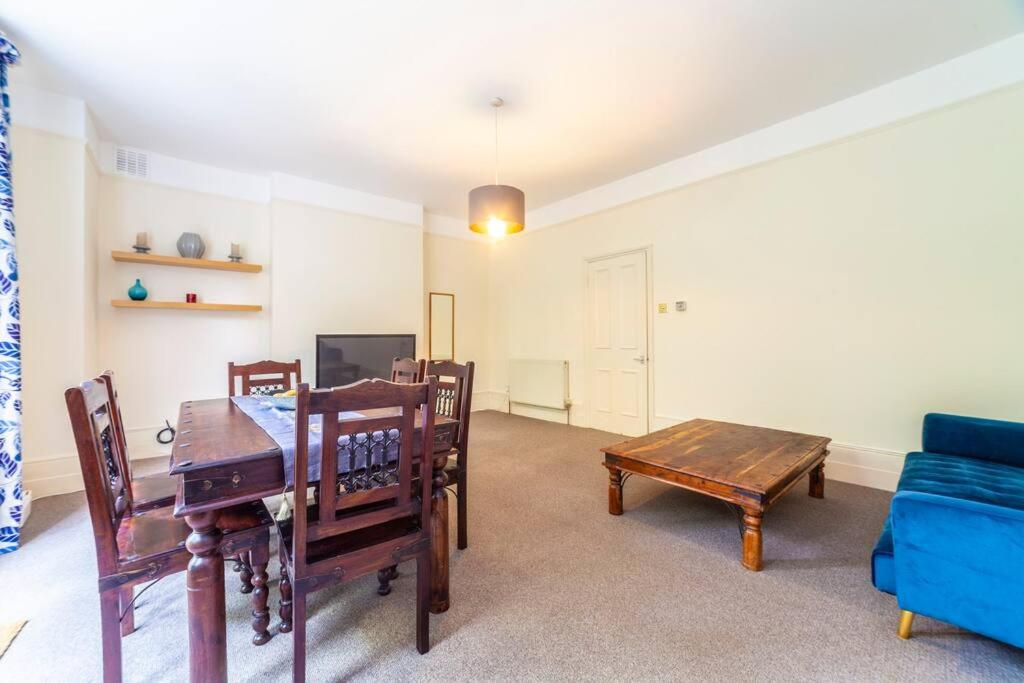 a living room with a blue couch and a table at Amazing 1BD in Victorian house - Lewisham Park in London