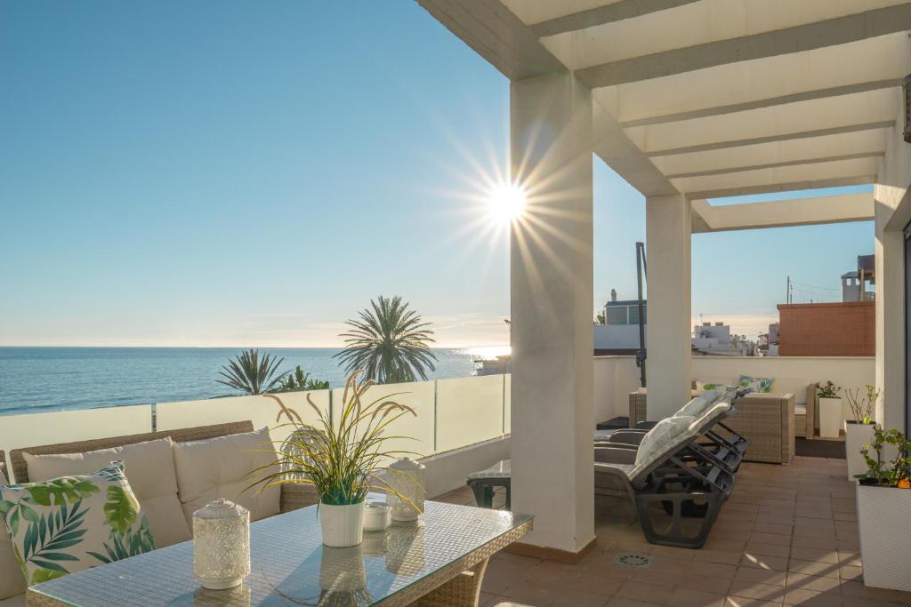 a patio with a view of the ocean at Apartamentos Varadero On the beach in Cala del Moral