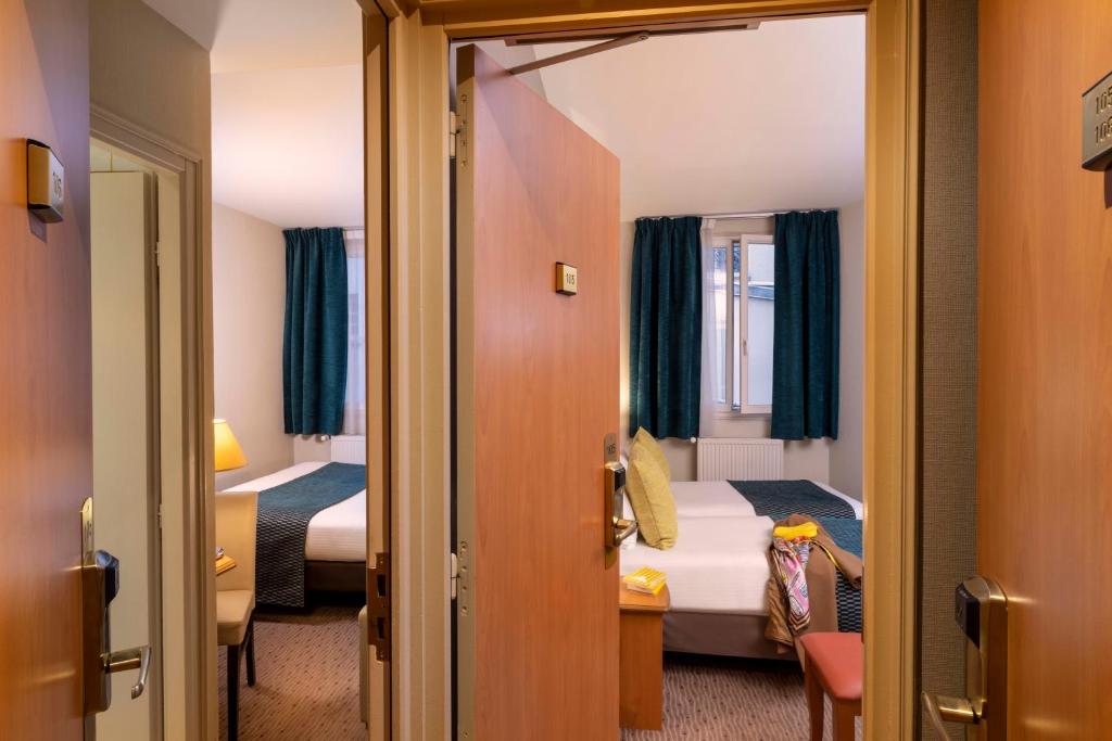 Un ou plusieurs lits dans un hébergement de l'établissement Hôtel L'Interlude
